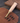 Leather tool with wooden handle and brass components on a leather surface